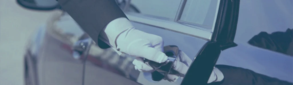 Meet and greet chauffeur opening a car door for an airport transfer